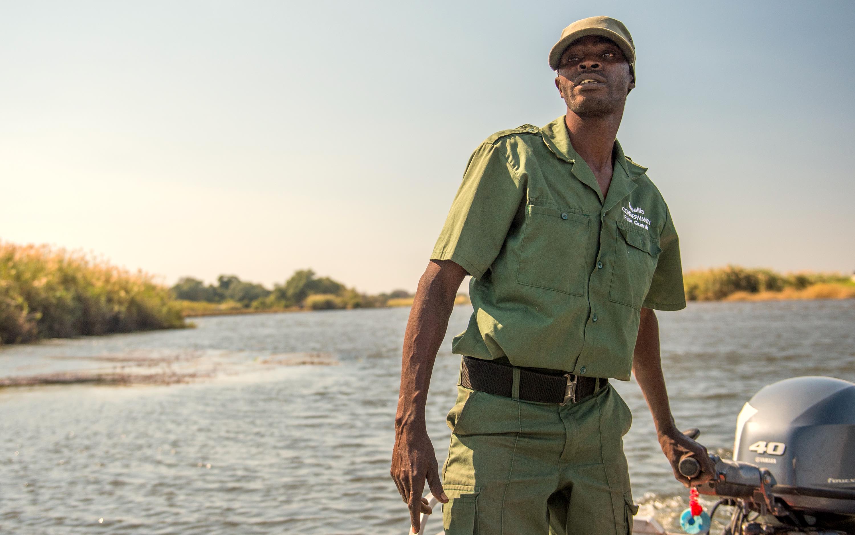 A community fish guard on patrol in his boat.