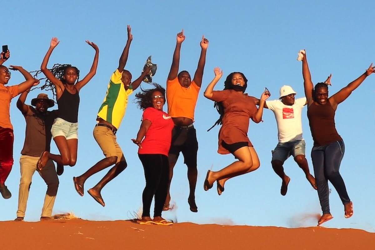 One of the trainees watches as a giraffe runs into the distance.