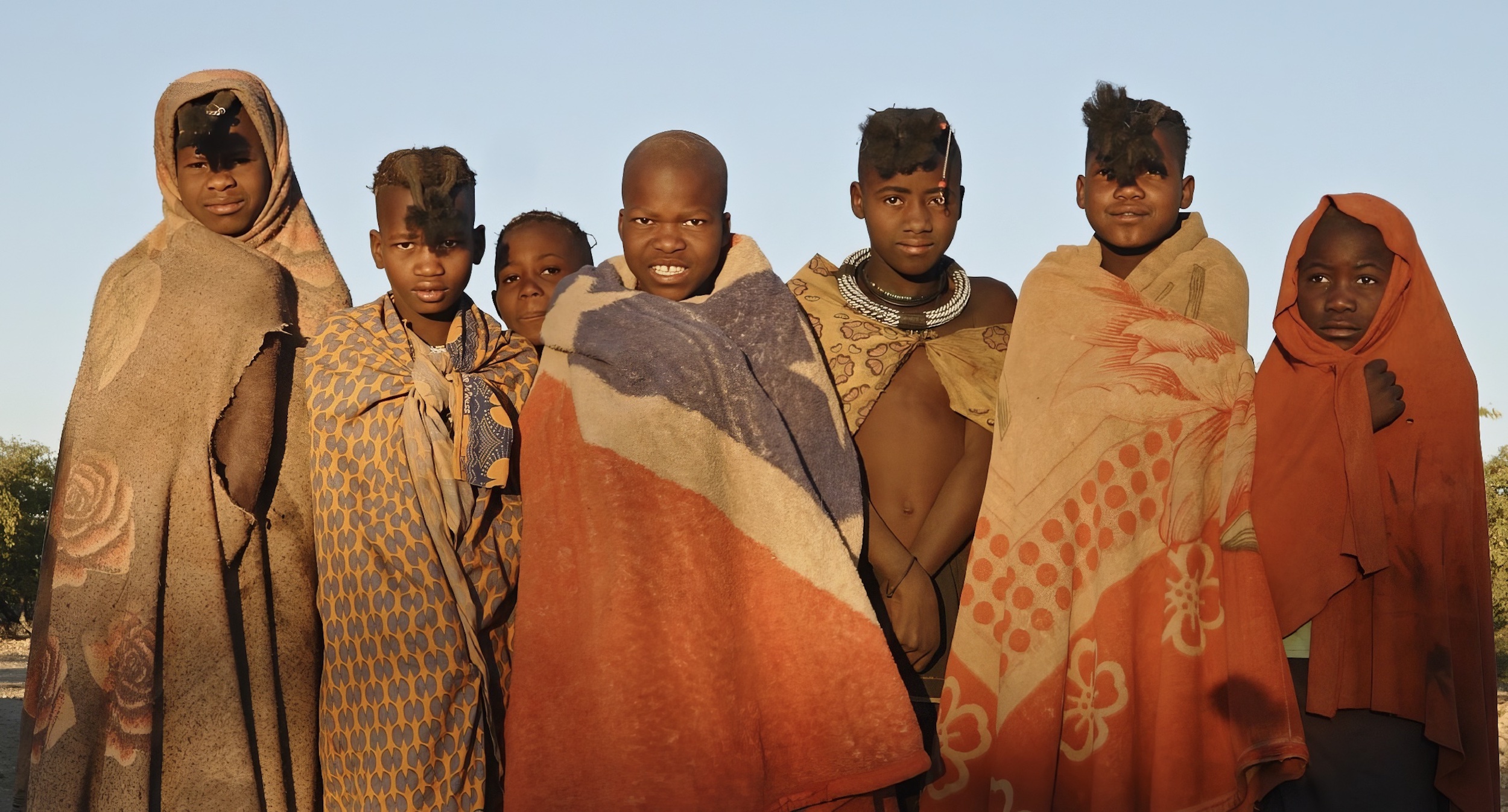 Seven members of the local communities pose for the camera.