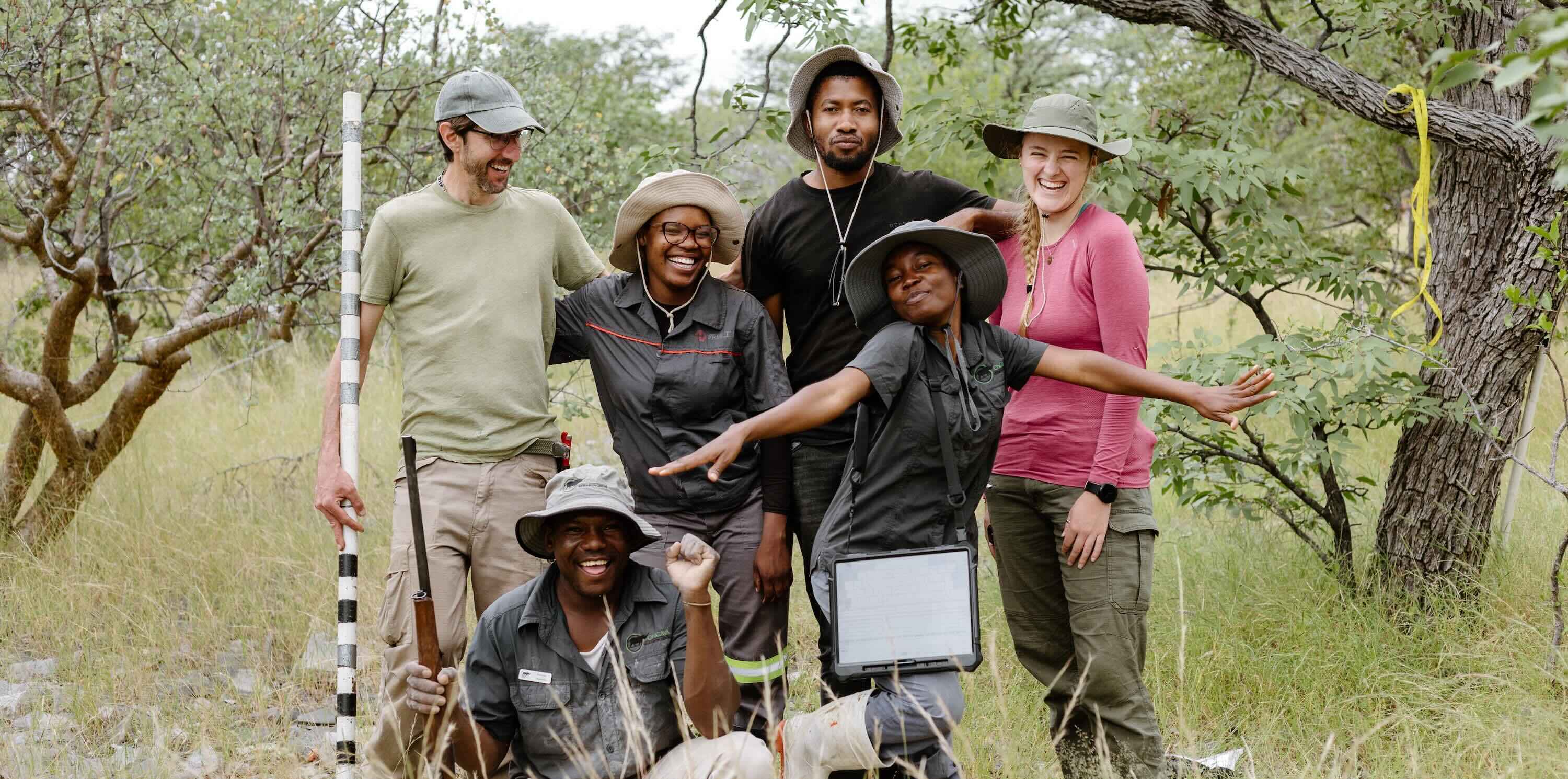 Six members of the team pose for a photo in the field with some of their equipment.