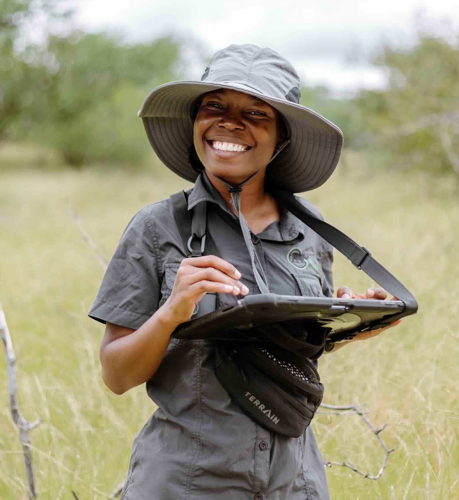 Leena Naftal holds a tablet and smiles for the camera.