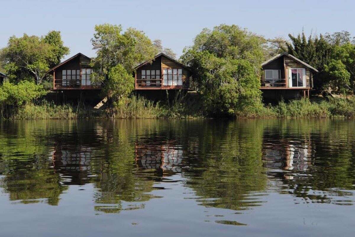 Three luxury chalets overlooking a wide river.