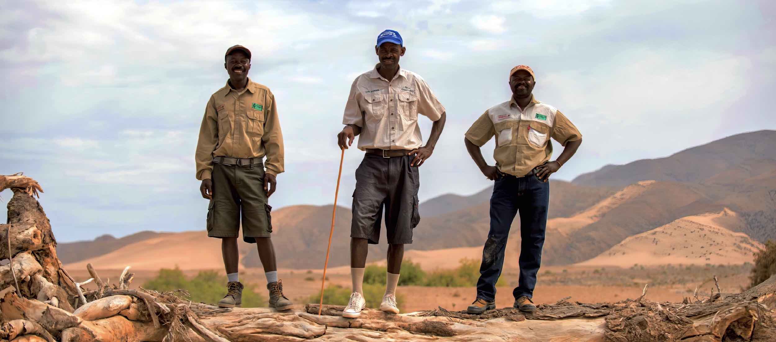 Three community game guards standing side by side.