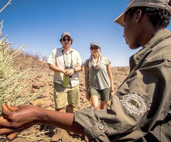 A guide talks to two tourists